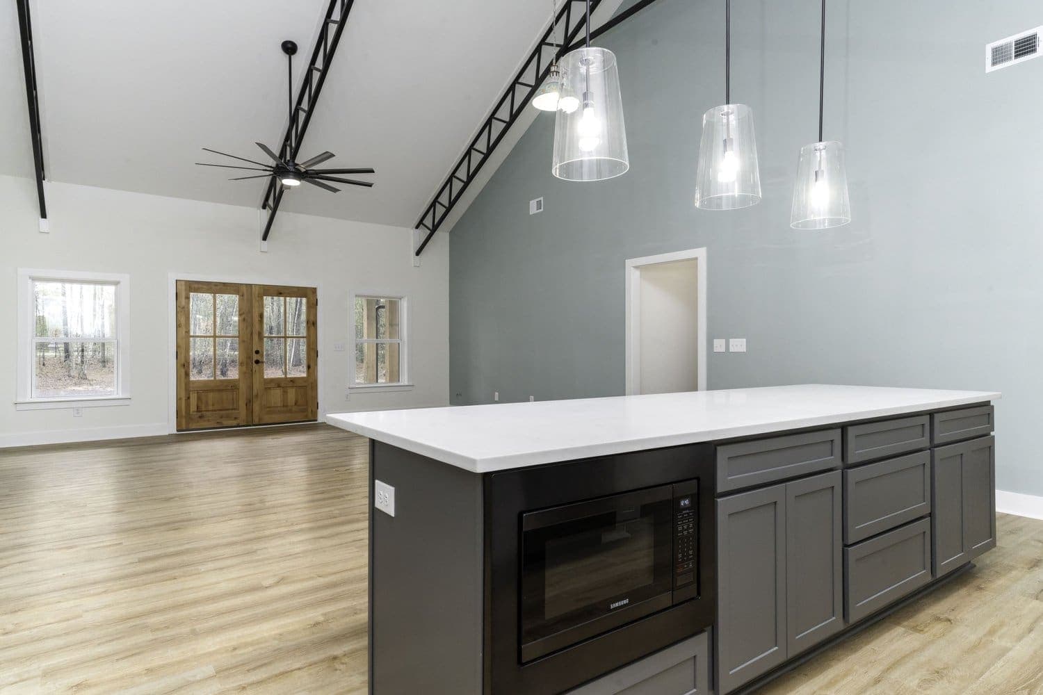 Large custom kitchen island in a completed barndominium